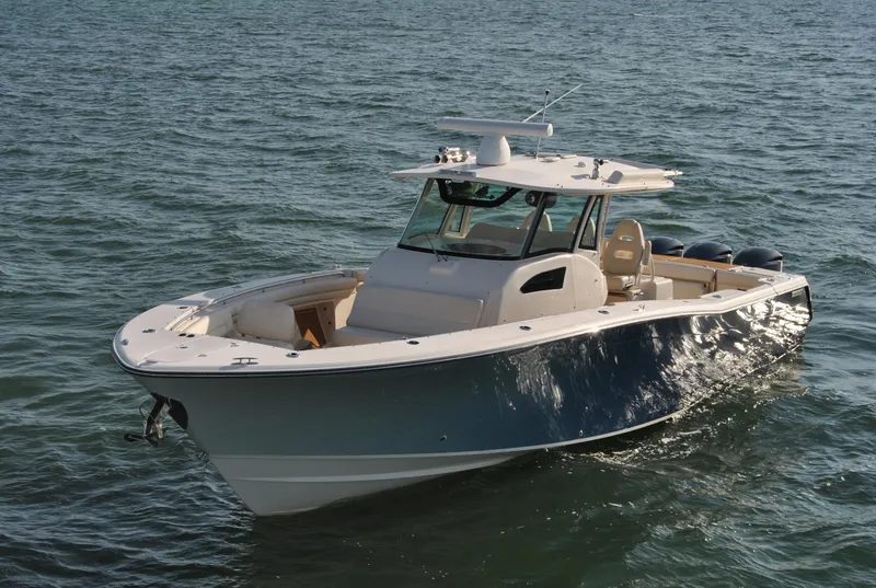 Slide: The Image of 2018 Grady-White Canyon 376 boat on open water, showcasing sleek design and spacious deck. - 45