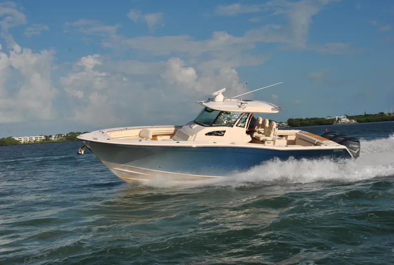 Slide: The Image of 2018 Grady-White Canyon 376 boat cruising on open water under a clear sky. - 46