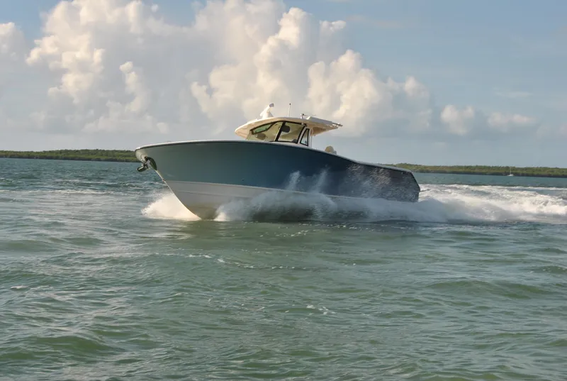 Slide: The Image of 2018 Grady-White Canyon 376 boat cruising on open water under a cloudy sky. - 48