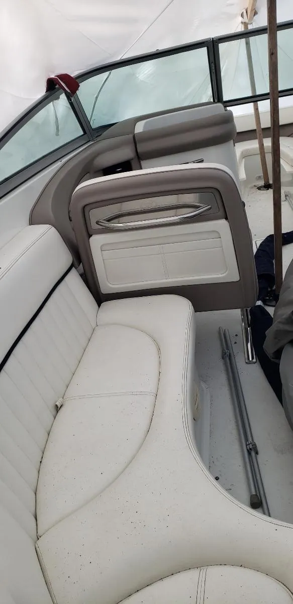 Slide: The Image of Interior of a 2005 Cobalt 282 boat with white seating and windshield. - 10