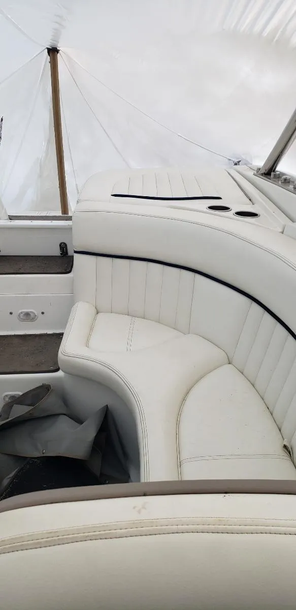 Slide: The Image of 2005 Cobalt 282 boat interior with white leather seating and sleek design. - 11