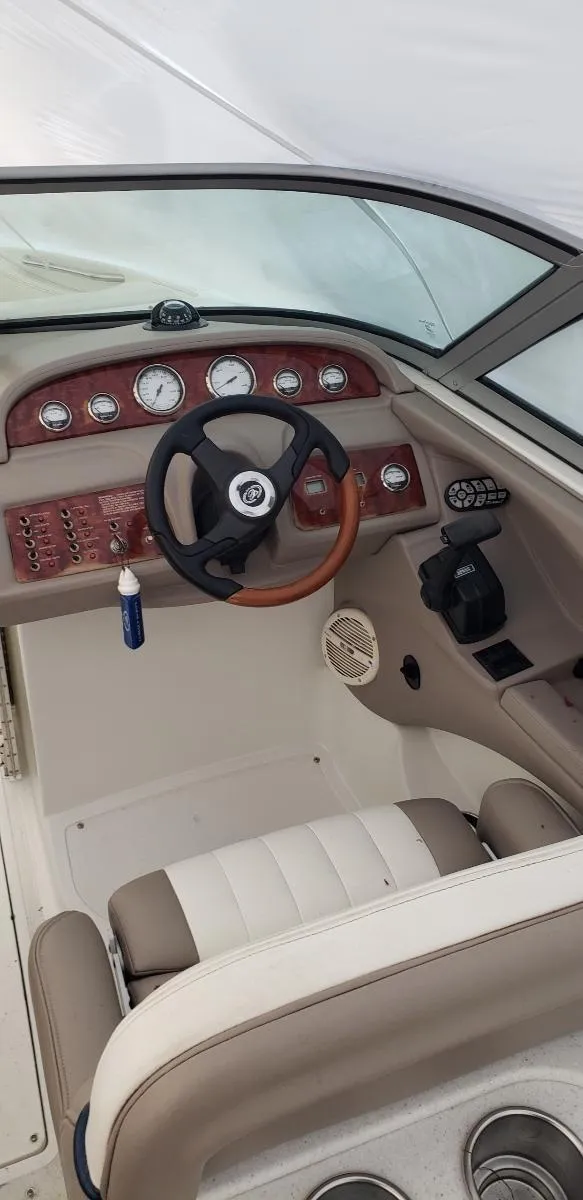 Slide: The Image of 2005 Cobalt 282 boat interior with steering wheel and dashboard controls. - 13