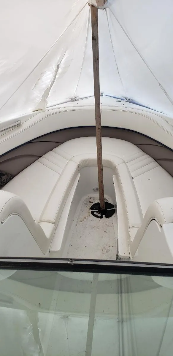 Slide: The Image of 2005 Cobalt 282 boat interior with white seating and protective cover. - 6