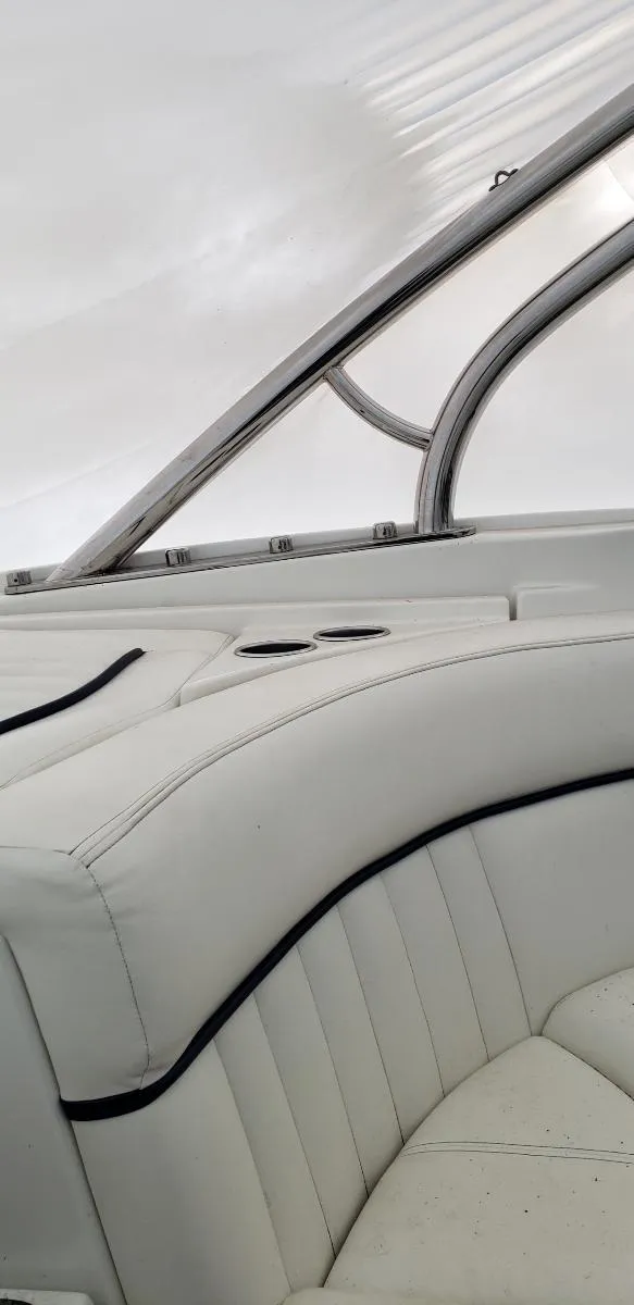 Slide: The Image of 2005 Cobalt 282 boat interior with white leather seating and sleek design. - 7