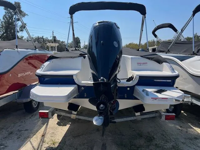 Slide: The Image of 2025 Bayliner Element E18 boat with outboard motor, docked on a trailer. - 3