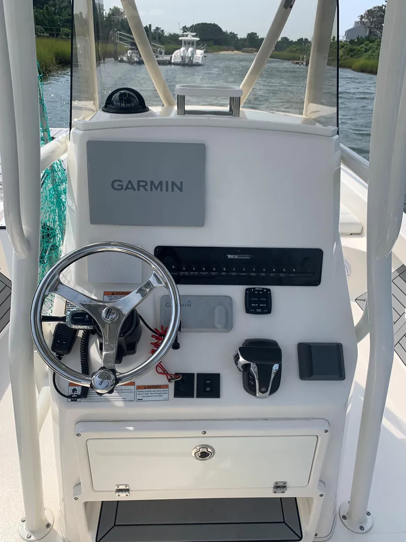 Slide: The Image of Pathfinder 2600 TRS 2021 boat console with Garmin navigation system on a river. - 12
