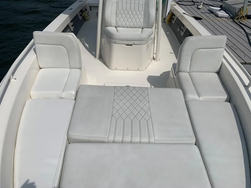 Slide: The Image of 2021 Pathfinder 2600 TRS boat interior with white cushioned seating. - 16