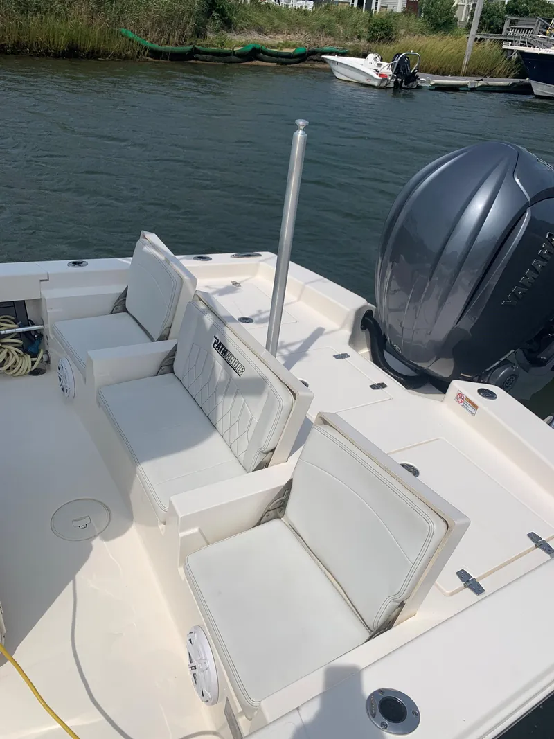 Slide: The Image of 2021 Pathfinder 2600 TRS boat interior with seating and outboard motor. - 22