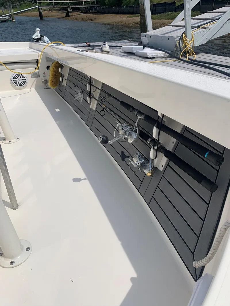 Slide: The Image of 2021 Pathfinder 2600 TRS boat with fishing rods and gear storage. - 25