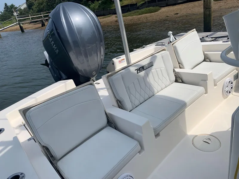 Slide: The Image of 2021 Pathfinder 2600 TRS boat interior with Yamaha engine, featuring white cushioned seating. - 26