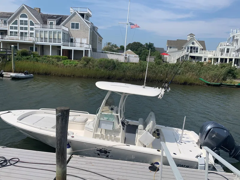 Slide: The Image of 2021 Pathfinder 2600 TRS boat docked near waterfront homes. - 6