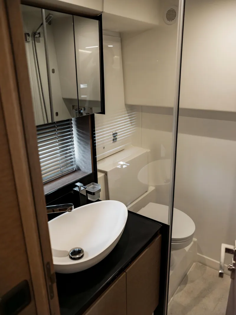 Slide: The Image of Modern bathroom in 2022 Prestige 460F yacht with sleek sink and mirror. - 12