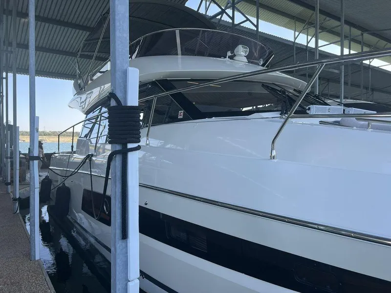 Slide: The Image of Prestige 460F 2022 yacht docked in a covered marina. - 14