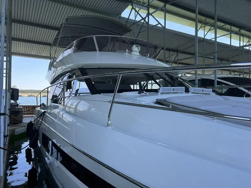 Slide: The Image of 2022 Prestige 460F yacht docked under a covered marina. - 16