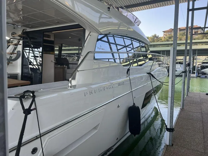 Slide: The Image of 2022 Prestige 460F yacht docked in marina, sleek design, modern interior visible. - 19