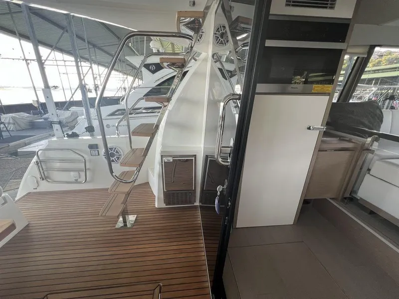Slide: The Image of Interior view of 2022 Prestige 460F yacht with wooden deck and modern design. - 28