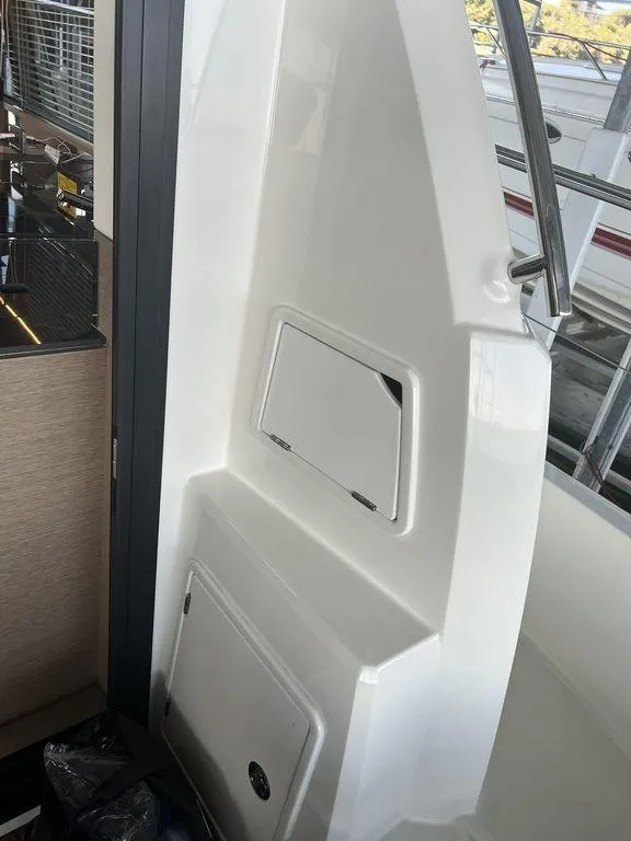 Slide: The Image of Interior view of 2022 Prestige 460F yacht, featuring sleek white paneling and modern design elements. - 32