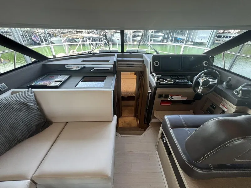 Slide: The Image of Interior of 2022 Prestige 460F yacht with modern helm and seating area. - 36