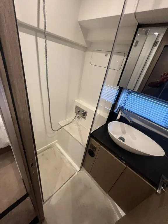 Slide: The Image of Modern bathroom in 2022 Prestige 460F yacht with sleek sink and shower area. - 38