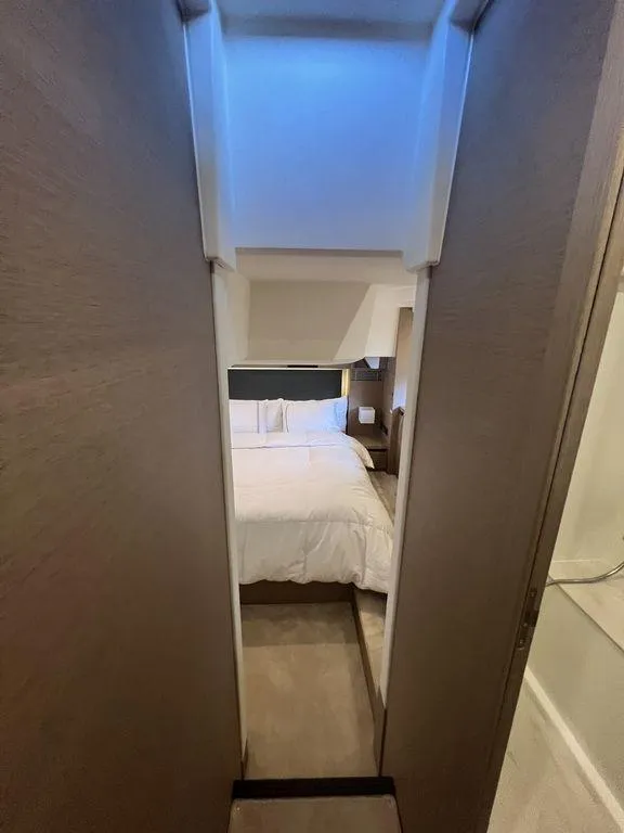 Slide: The Image of Luxurious bedroom interior of 2022 Prestige 460F yacht, featuring modern design and cozy ambiance. - 39