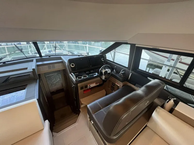 Slide: The Image of Interior of 2022 Prestige 460F yacht, featuring modern helm and seating area. - 46