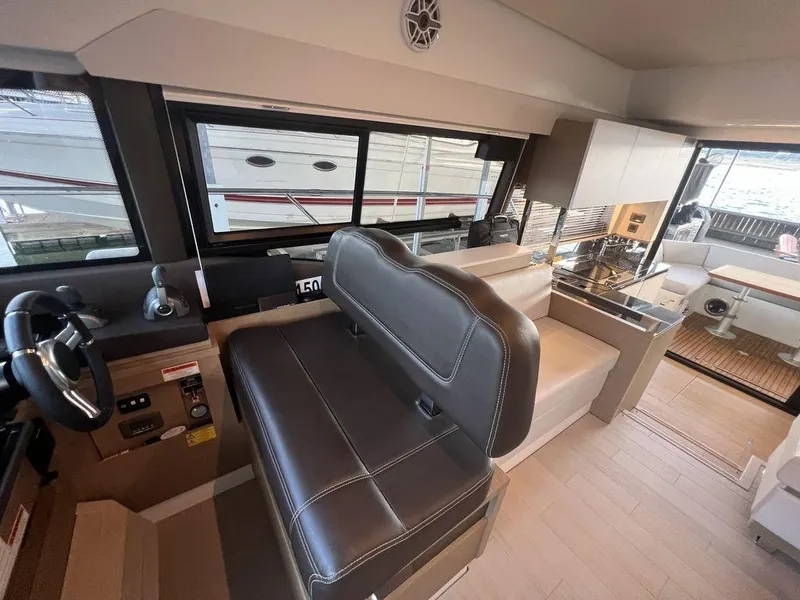 Slide: The Image of Interior of 2022 Prestige 460F yacht with modern seating and kitchen area. - 47