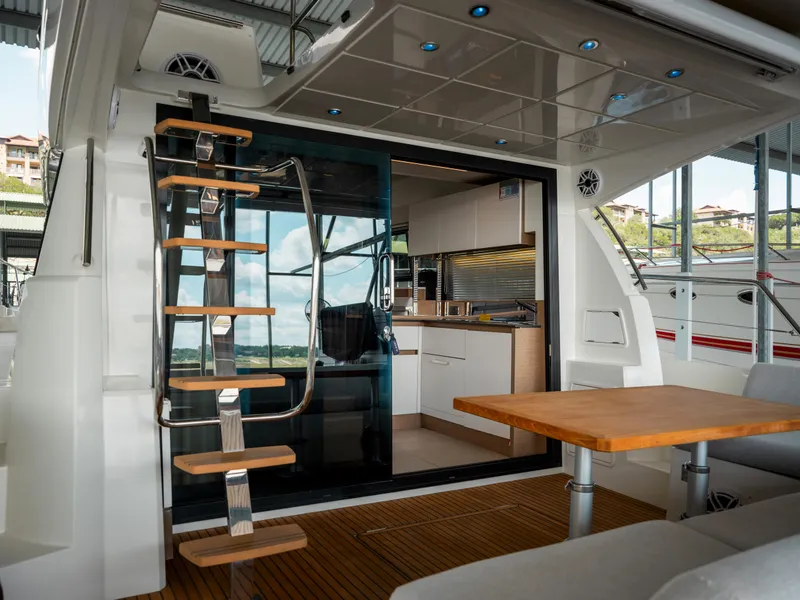 Slide: The Image of Interior view of 2022 Prestige 460F yacht with modern kitchen and wooden accents. - 5