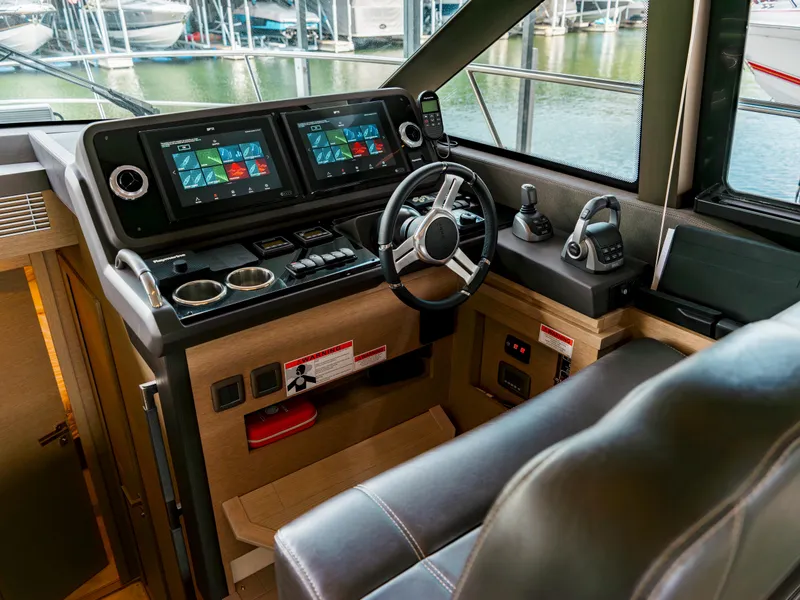 Slide: The Image of 2022 Prestige 460F yacht helm with dual displays and modern controls. - 7