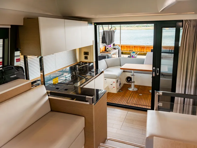 Slide: The Image of Luxurious interior of 2022 Prestige 460F yacht with modern kitchen and seating area. - 8