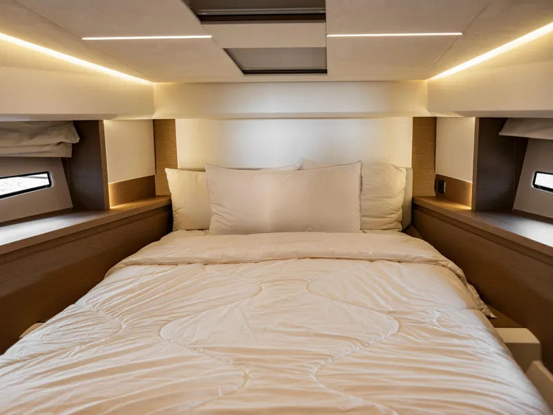Slide: The Image of Luxurious bedroom interior of 2022 Prestige 460F yacht with modern lighting and cozy bedding. - 9