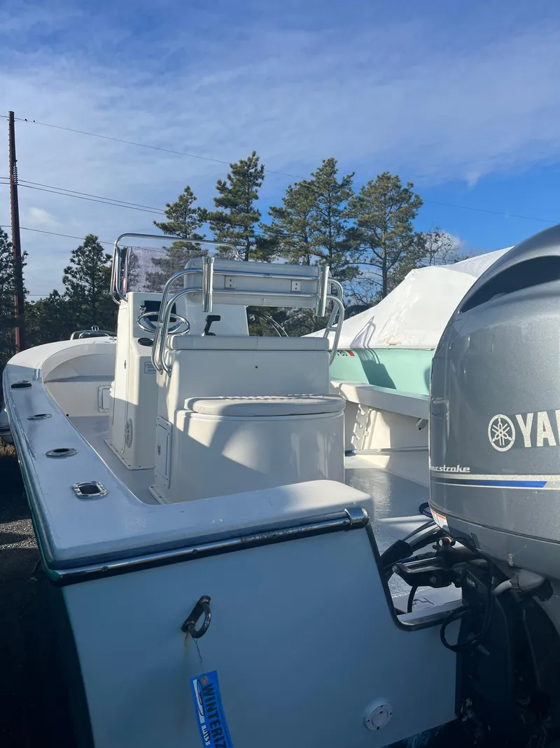 Slide: The Image of 2022 May-Craft 23 Cape Classic boat with Yamaha outboard motor, parked outdoors. - 2