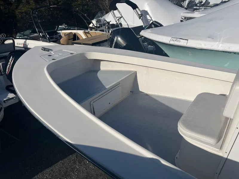 Slide: The Image of 2022 May-Craft 23 Cape Classic boat interior with seating and storage. - 3