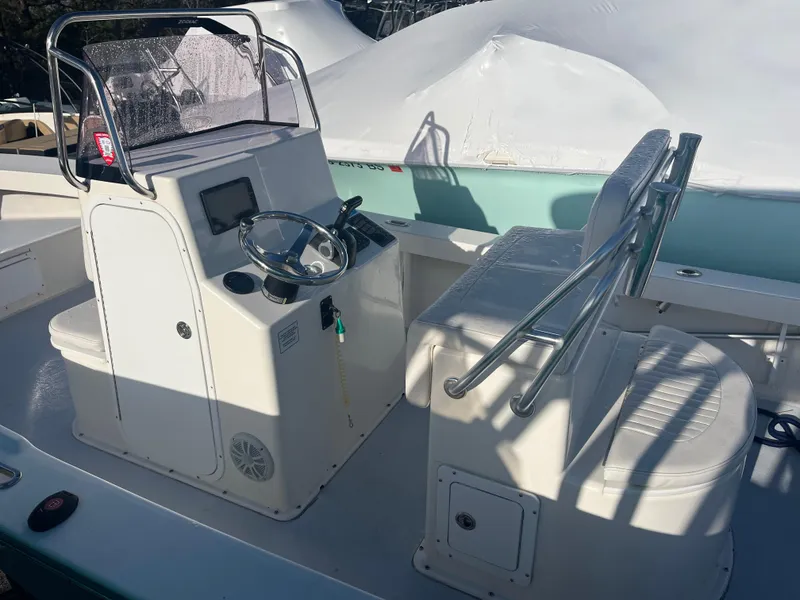 Slide: The Image of 2022 May-Craft 23 Cape Classic boat interior with steering console and seating. - 4