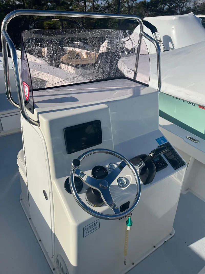 Slide: The Image of 2022 May-Craft 23 Cape Classic boat console with steering wheel and controls. - 5