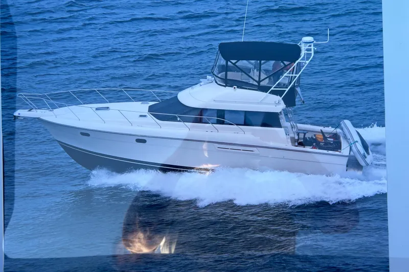 Slide: The Image of 1991 Silverton 41 Convertible yacht cruising on open water. - 0