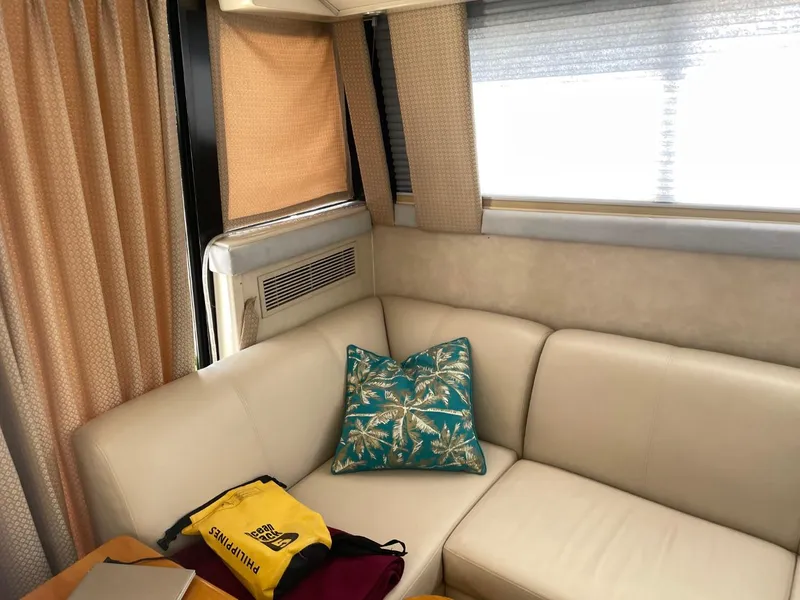 Slide: The Image of Interior of 1991 Silverton 41 Convertible yacht with beige sofa and tropical pillow. - 10