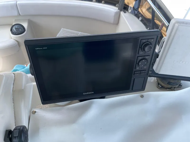 Slide: The Image of Garmin GPS device on 1991 Silverton 41 Convertible boat dashboard. - 19