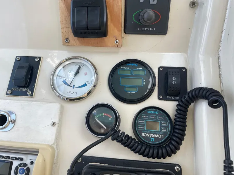 Slide: The Image of Control panel of a 1991 Silverton 41 Convertible boat with gauges and switches. - 23