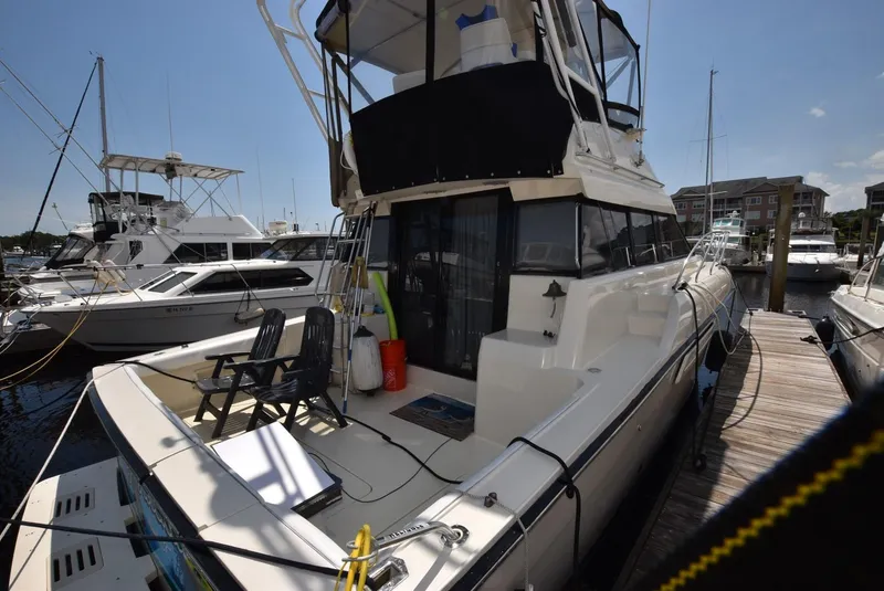 Slide: The Image of 1991 Silverton 41 Convertible yacht docked at marina, rear view. - 34