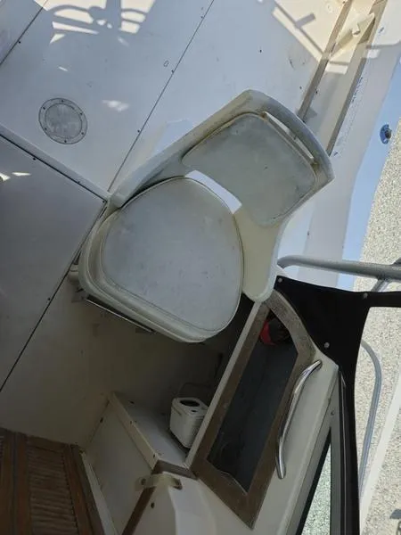 Slide: The Image of 1990 Grady-White 230 Gulfstream boat interior with seating and storage. - 13