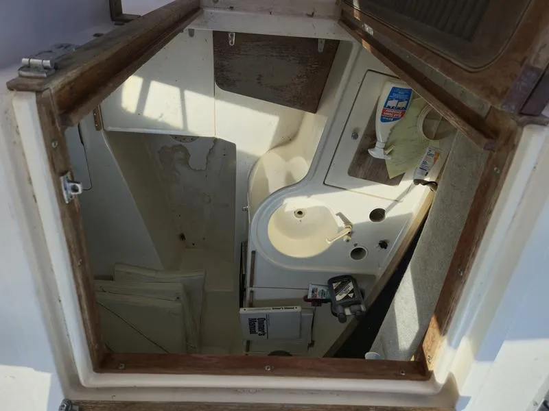 Slide: The Image of 1990 Grady-White 230 Gulfstream cabin interior with sink and storage. - 16
