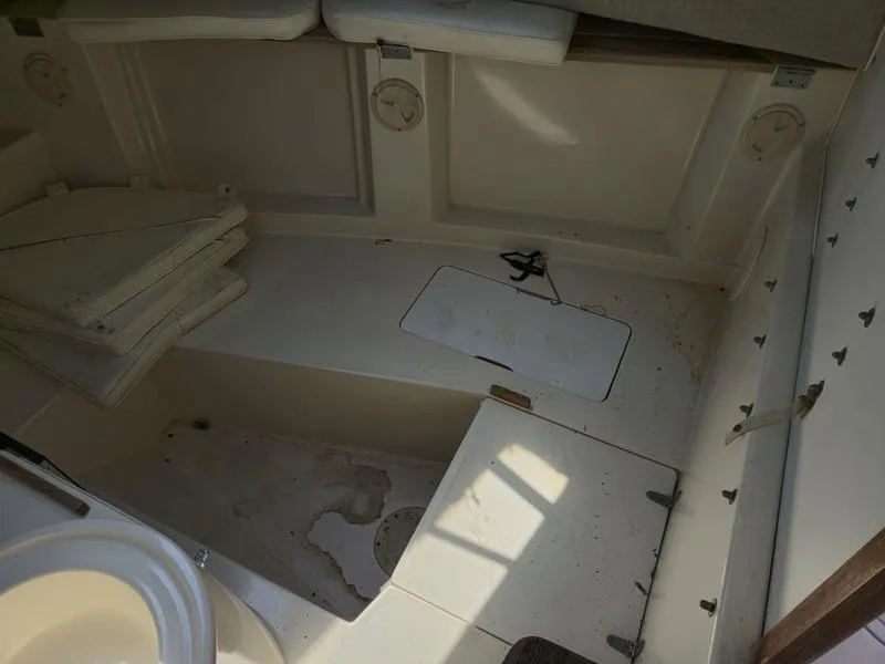 Slide: The Image of 1990 Grady-White 230 Gulfstream boat interior with storage compartments and seating. - 17