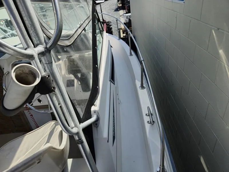 Slide: The Image of 1990 Grady-White 230 Gulfstream boat, side view, docked near a wall. - 18