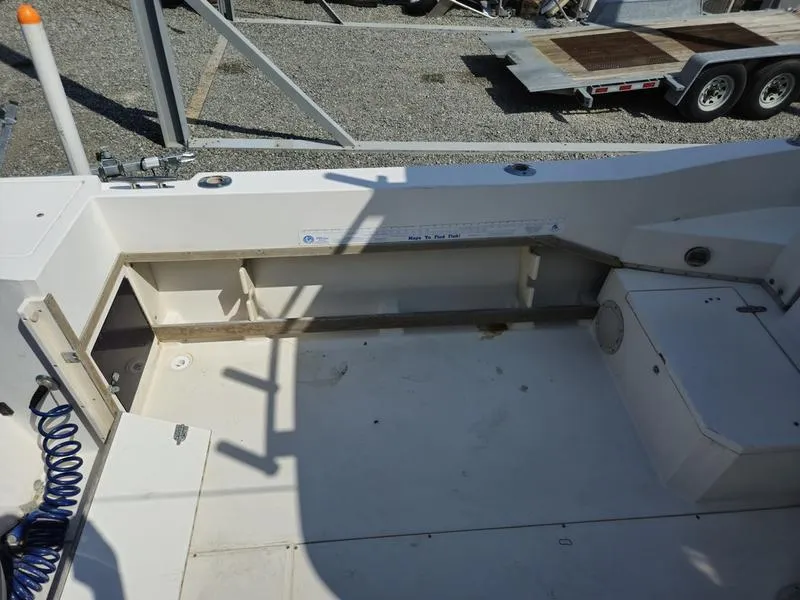 Slide: The Image of 1990 Grady-White 230 Gulfstream boat deck, spacious and clean, with storage compartments. - 24