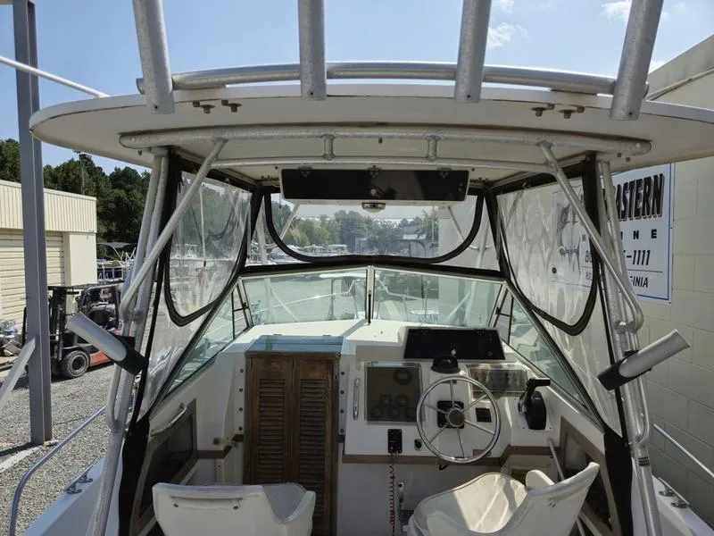 Slide: The Image of 1990 Grady-White 230 Gulfstream boat cockpit with steering wheel and controls. - 9