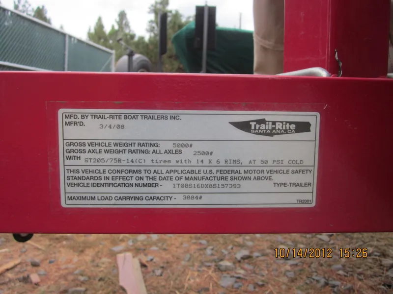 Slide: The Image of Label on a red trailer by Trail-Rite, detailing weight ratings and manufacturing information. - 13