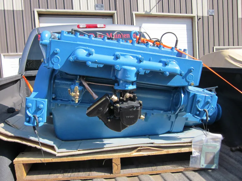 Slide: The Image of 1948 Chris-Craft Racer engine in truck bed, vibrant blue, industrial setting. - 22
