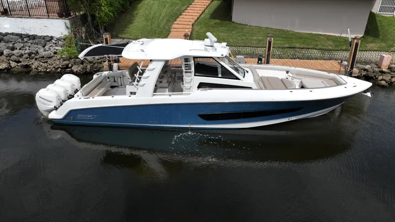 Slide: The Image of 2020 Boston Whaler 420 Outrage boat docked on calm water. - 1