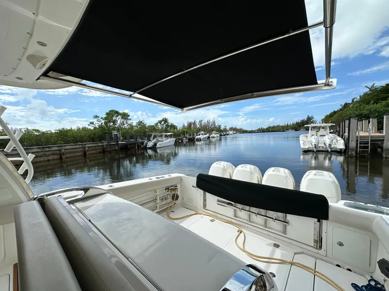 Slide: The Image of 2020 Boston Whaler 420 Outrage boat docked in serene marina setting. - 13