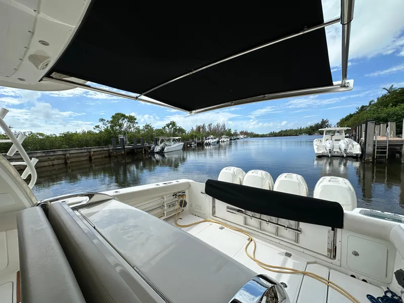 Slide: The Image of Boston Whaler 420 Outrage 2020, docked with scenic waterway view. - 14